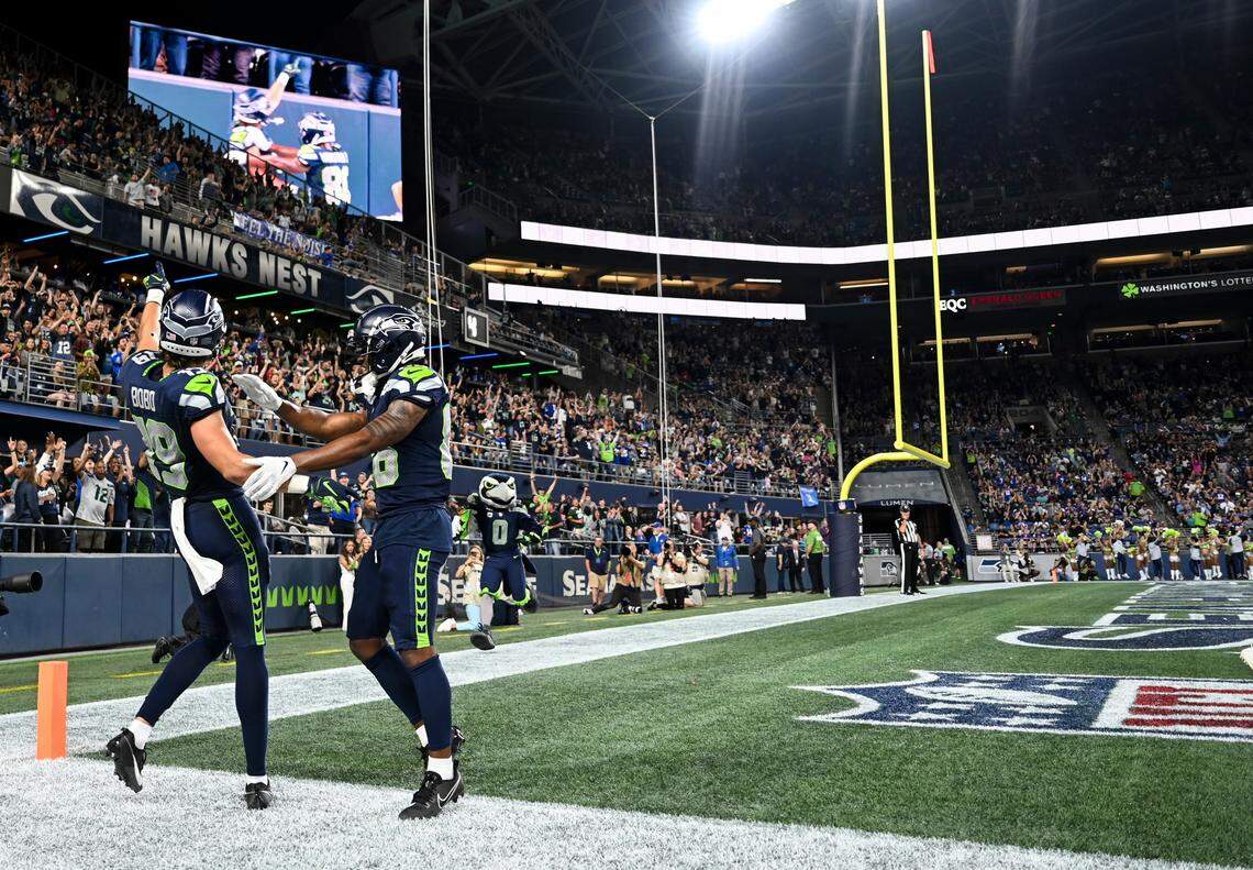 Seattle Seahawks wide receiver Jake Bobo (19) celebrates a touchdown with wide receiver Easop Winston Jr. (86) during the third quarter of the preseason game at Lumen Field, Thursday, Aug. 10, 2023, in Seattle, Wash.