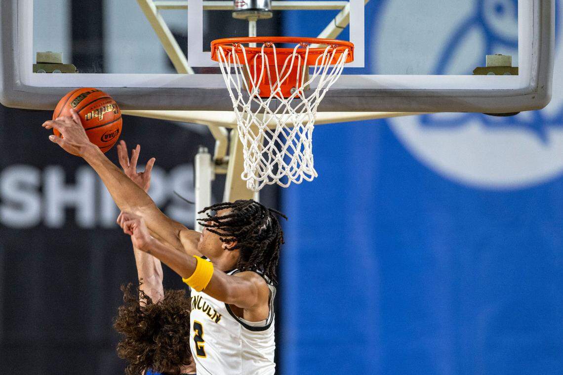 Lincoln’s Kasey Williams (2) blocks a shot attempt by Federal Way’s Brayden McVey (4) during the first half of a Class 3A state basketball tournament first-round game at the Tacoma Dome on Wednesday, March 5, 2025, in Tacoma, Wash.