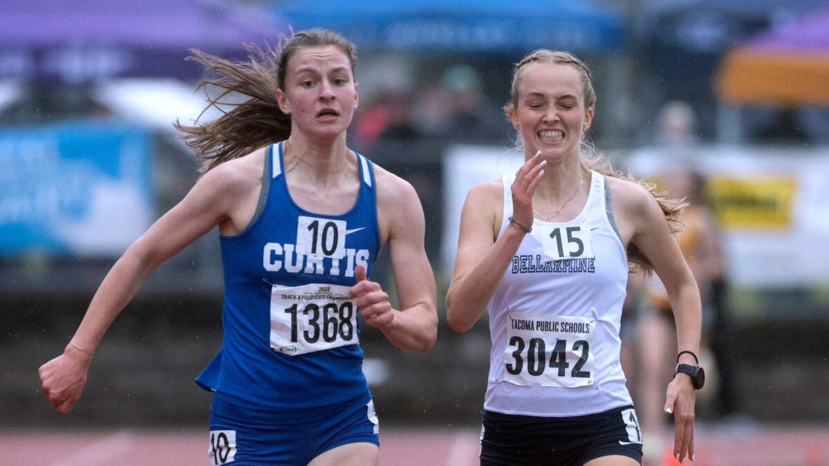 Curtis’ Eliza White (left) holds off a surging Bellarmine Prep’s Ella Borsheim to take the state championship in the 4A girls 3200-meter run during the final day of the WIAA State Track and Field Championships at Mount Tahoma High School in Tacoma, Washington on Saturday, May 28, 2022.