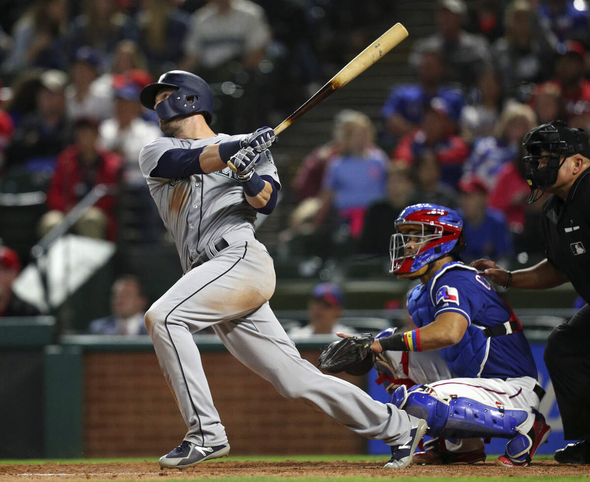 Seattle Mariners' Mitch Haniger (17) watches his home run against the Texas Rangers in the eighth inning of a baseball game Friday, April 20, 2018, in Arlington, Texas. (AP Photo/Richard W. Rodriguez)