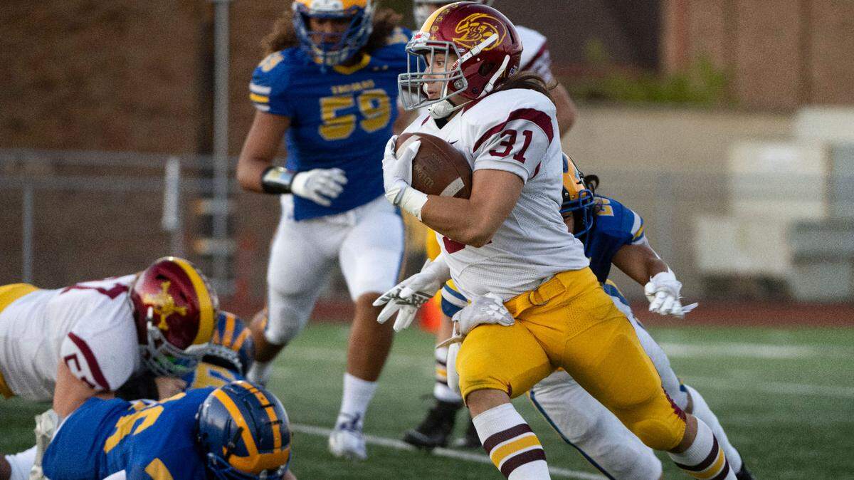 Enumclaw running back Emmit Otero looks to break through a tackle attempt by Fife’s Beau Fualaau during the first quarter of 2A SPSL game on Thursday, Sept. 22, 2022, at Fife High School in Fife, Wash.