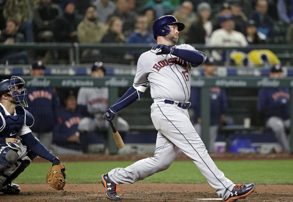 Houston Astros' Brian McCann, right, and Seattle Mariners catcher Mike Marjama watch the path of McCann's 2-run home run in the sixth inning of a baseball game Tuesday, April 17, 2018, in Seattle. (AP Photo/Elaine Thompson)