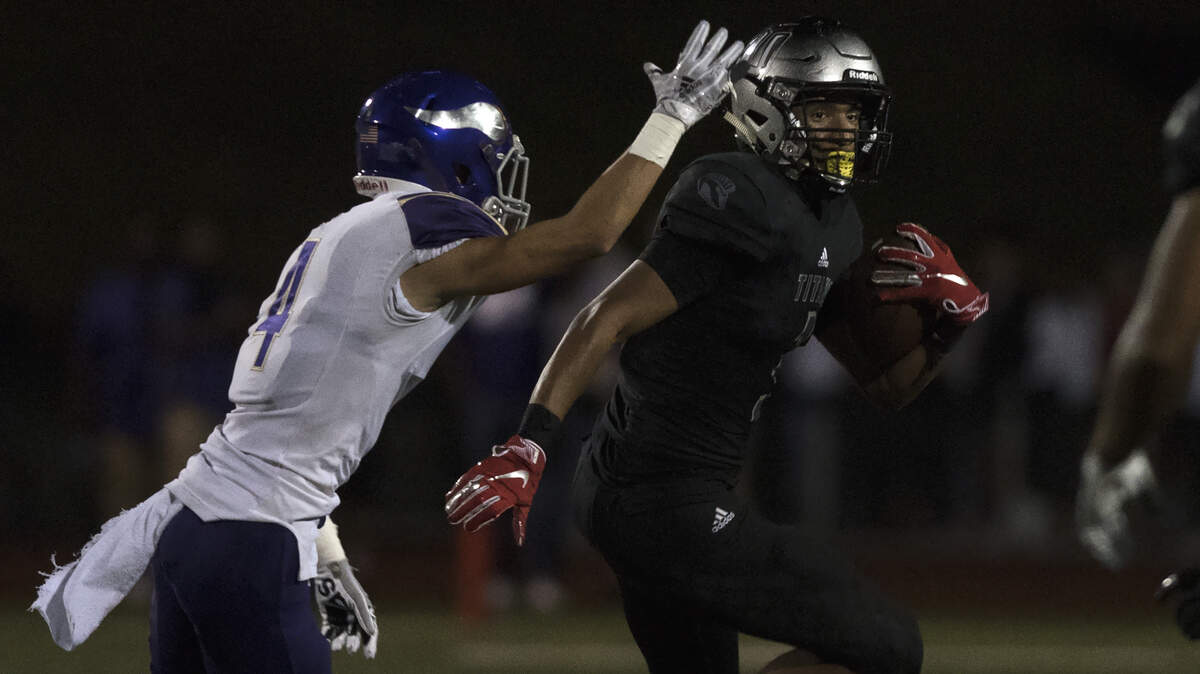 Union High School receiver Darien Chase searches for space after securing a catch with a Puyallup defender in pursuit. The Titans played the Vikings on Friday, Sept. 28, 2018 at McKenzie Stadium in Vancouver.