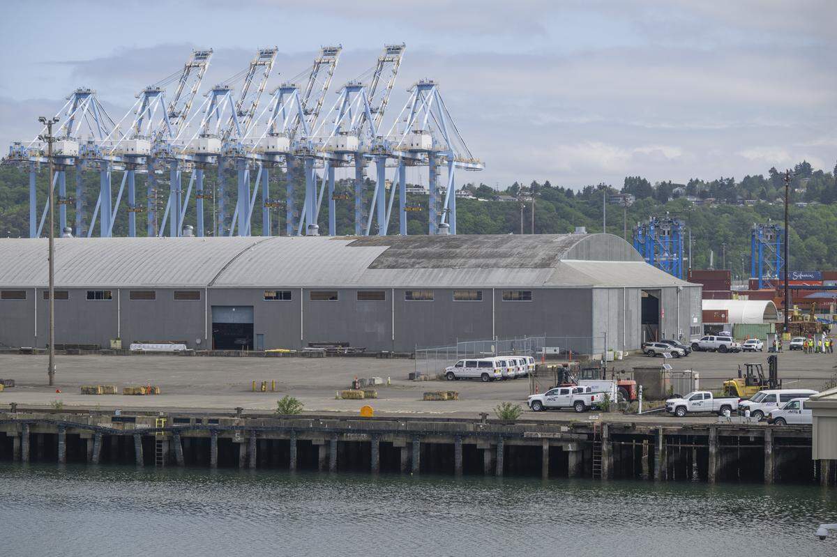 A set cranes at the Husky Terminal of the Port of Tacoma, left, are pictured on Thursday, May 7, 2026, in Tacoma, Wash. These cranes are operated by a tenant that has requested to install equipment that could eliminate marine clerk jobs.