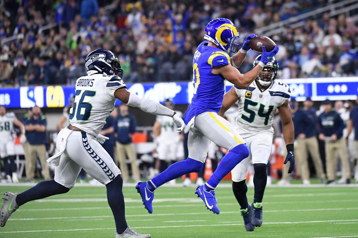 Los Angeles Rams wide receiver Cooper Kupp (10) catches a pass then runs for a touchdown past Seattle Seahawks outside linebacker Jordyn Brooks (56) and middle linebacker Bobby Wagner (54) during the second half of an NFL football game Tuesday, Dec. 21, 2021, in Inglewood, Calif. (AP Photo/Kevork Djansezian)