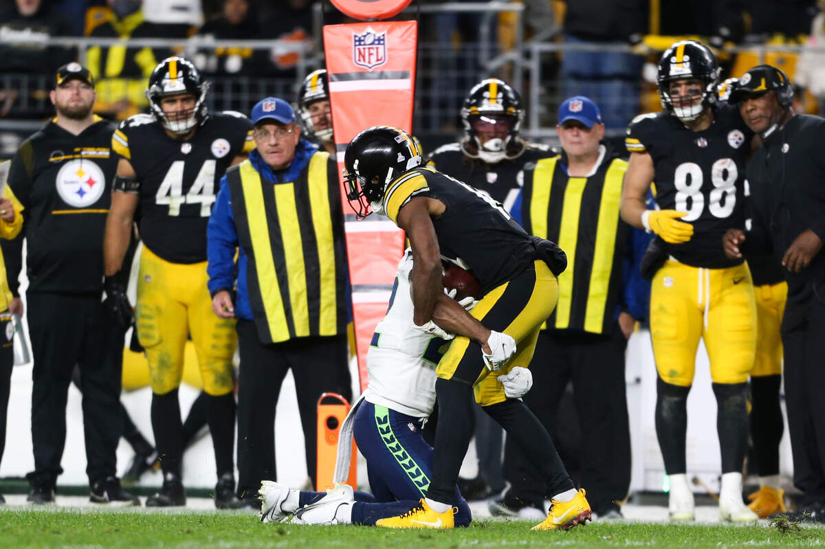 Seattle Seahawks cornerback Tre Brown (22) tackles Pittsburgh Steelers wide receiver Ray-Ray McCloud (14) to force a fourth down in overtime. The Seattle Seahawks played the Pittsburgh Steelers at Heinz Field in Pittsburgh, Pa., on Sunday, Oct. 17, 2021.