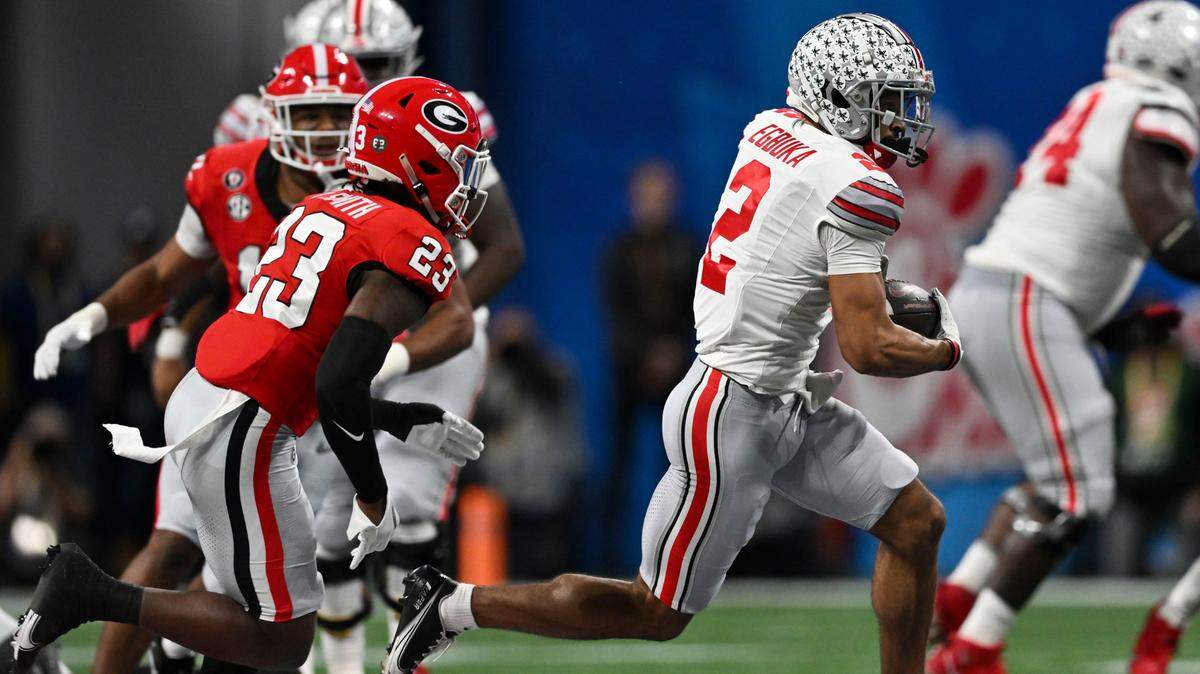 Ohio State wide receiver Emeka Egbuka (2) runs against Georgia defensive back Tykee Smith (23) during the first half of the Peach Bowl NCAA college football semifinal playoff game, Saturday, Dec. 31, 2022, in Atlanta. (AP Photo/Danny Karnik)