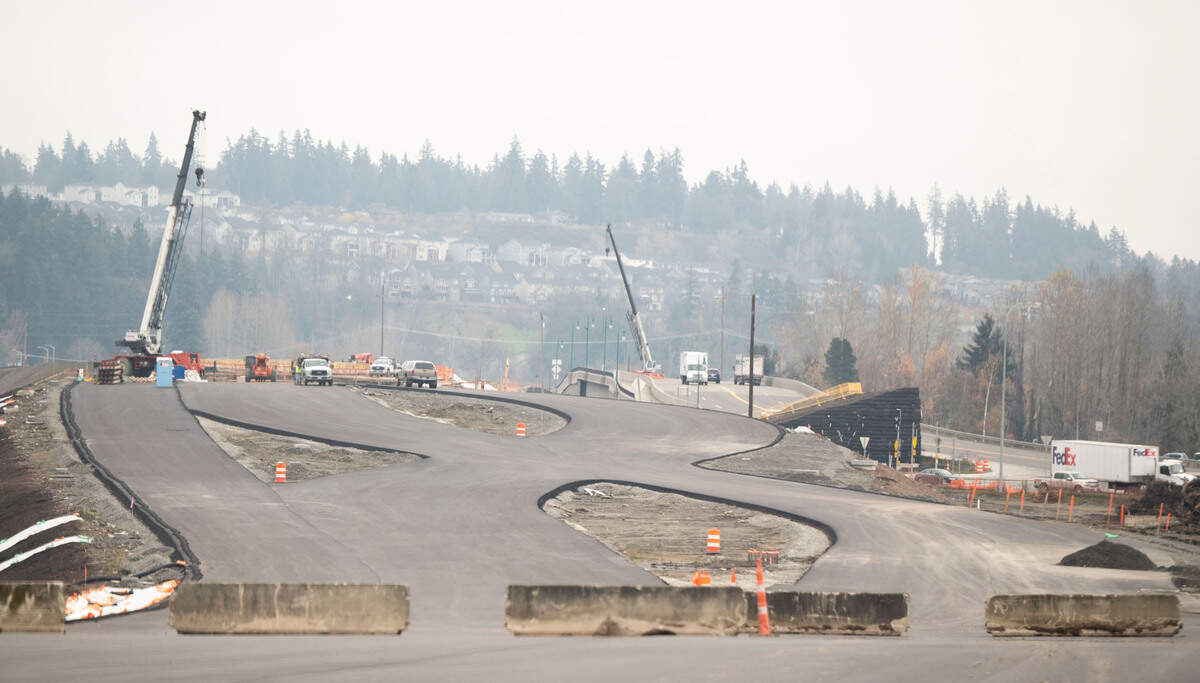 Construction crews work on a diverging-diamond interchange on the western side of State Route 167 and I-5, on Monday, Dec. 2, 2024, in Tacoma.