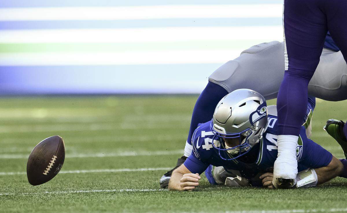 Seattle Seahawks quarterback Sam Darnold (14) nearly loses the ball during the second quarter of the game against the Minnesota Vikings at Lumen Field, on Sunday, Nov. 30, 2025, in Seattle. He was ruled down.