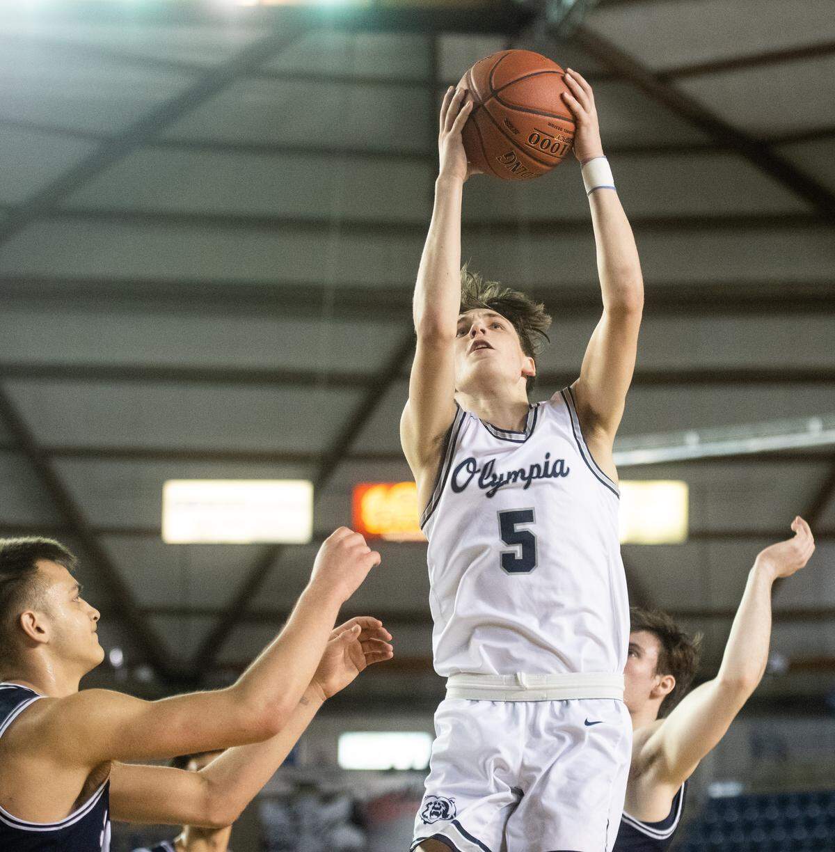 Olympia’s Kai Johnson grabs a rebound during the second quarter. Olympia played Skyview in a basketball game at Hardwood Classic at the Tacoma Dome in Tacoma, Wash., on Friday, March 6, 2020.
