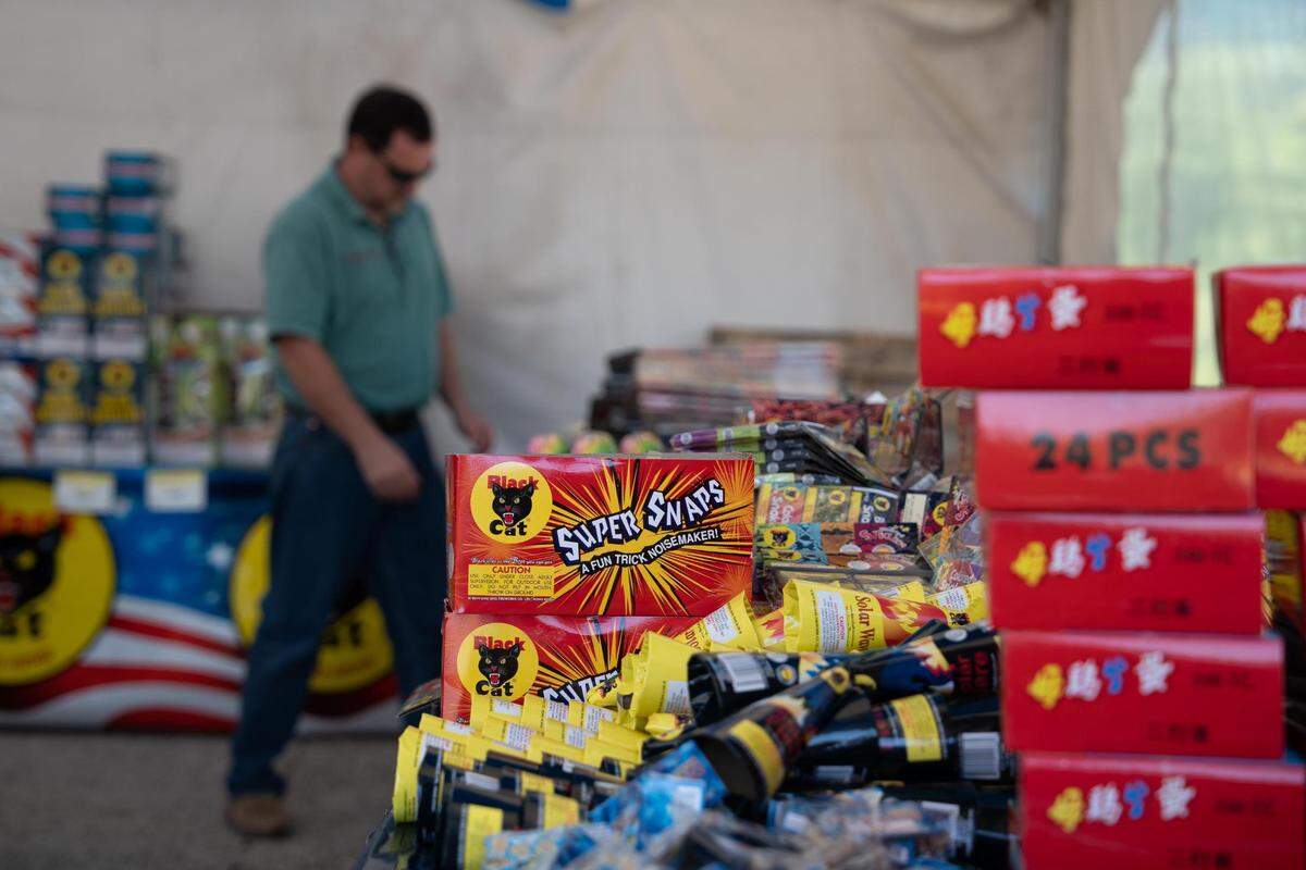Jon Ashlock looks through the fireworks selection at the Black Cat Fireworks pop-up shop at 5524 Soundview Dr. in Gig Harbor, Wash. The pop-up shop is one of the many that will be affected by a fireworks ban that takes effect in Gig Harbor next year.