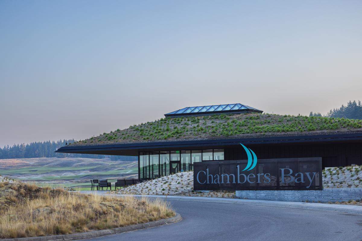 The Landing at Chambers Bay, a new cafe and bar, opens Oct. 10, 2025, at Chambers Bay Golf Course and Chambers Creek Regional Park. SHKS Architects designed the permanent structure to blend with the berms of the links-style course that surrounds it.