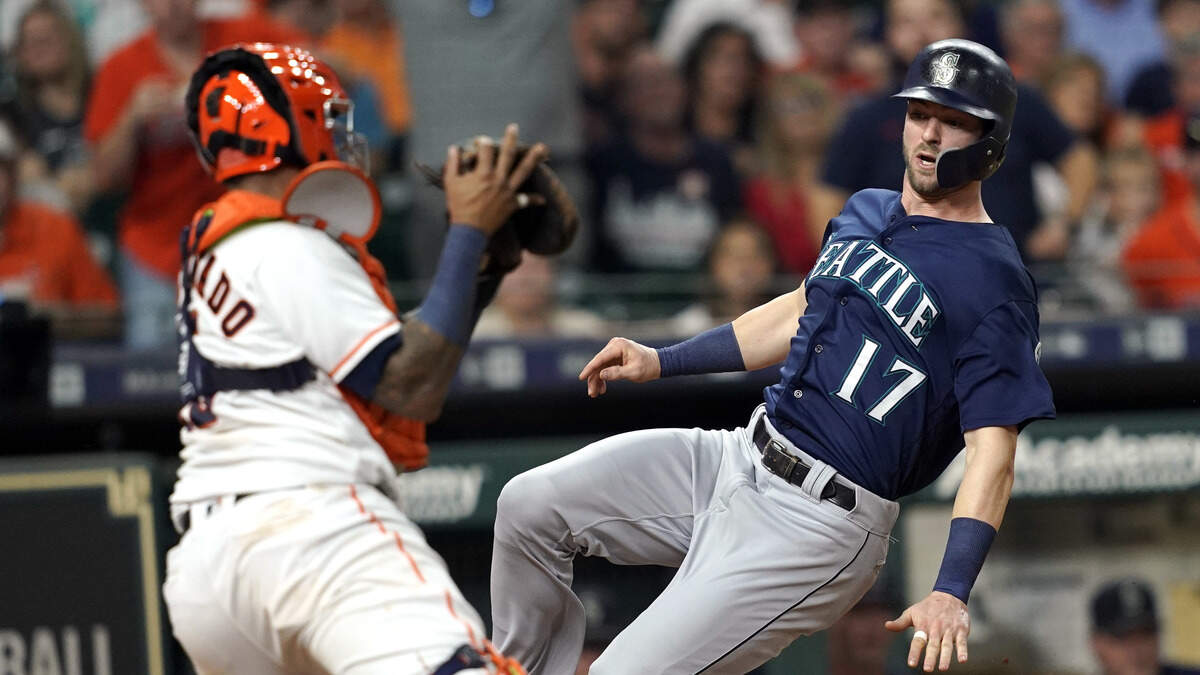 Seattle Mariners’ Mitch Haniger (17) scores as Houston Astros catcher Martin Maldonado reaches to tag him during the fifth inning of a baseball game Wednesday, Sept. 19, 2018, in Houston.(AP Photo/David J. Phillip)
