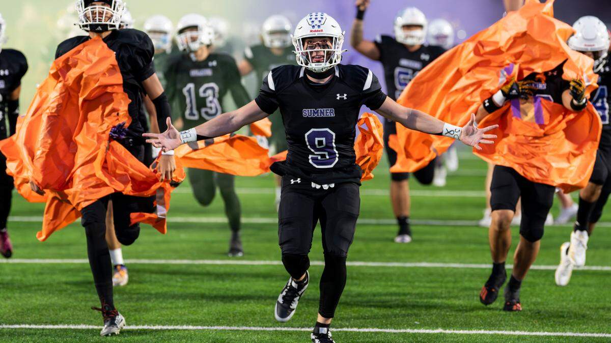 Sumner’s Carter Cocke (9) runs through the banner before the first half of the game against Puyallup at Sumner High School, on Thursday, Oct. 3, 2024, in Sumner, Wash.