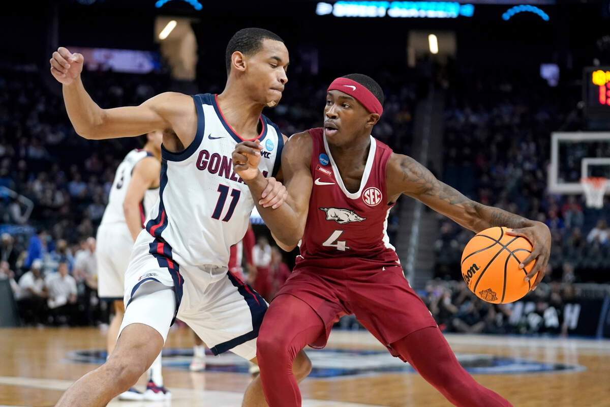 Arkansas guard Davonte Davis (4) is defended by Gonzaga guard Nolan Hickman (11) during the first half of a college basketball game in the Sweet 16 round of the NCAA tournament in San Francisco, Thursday, March 24, 2022. (AP Photo/Marcio Jose Sanchez)