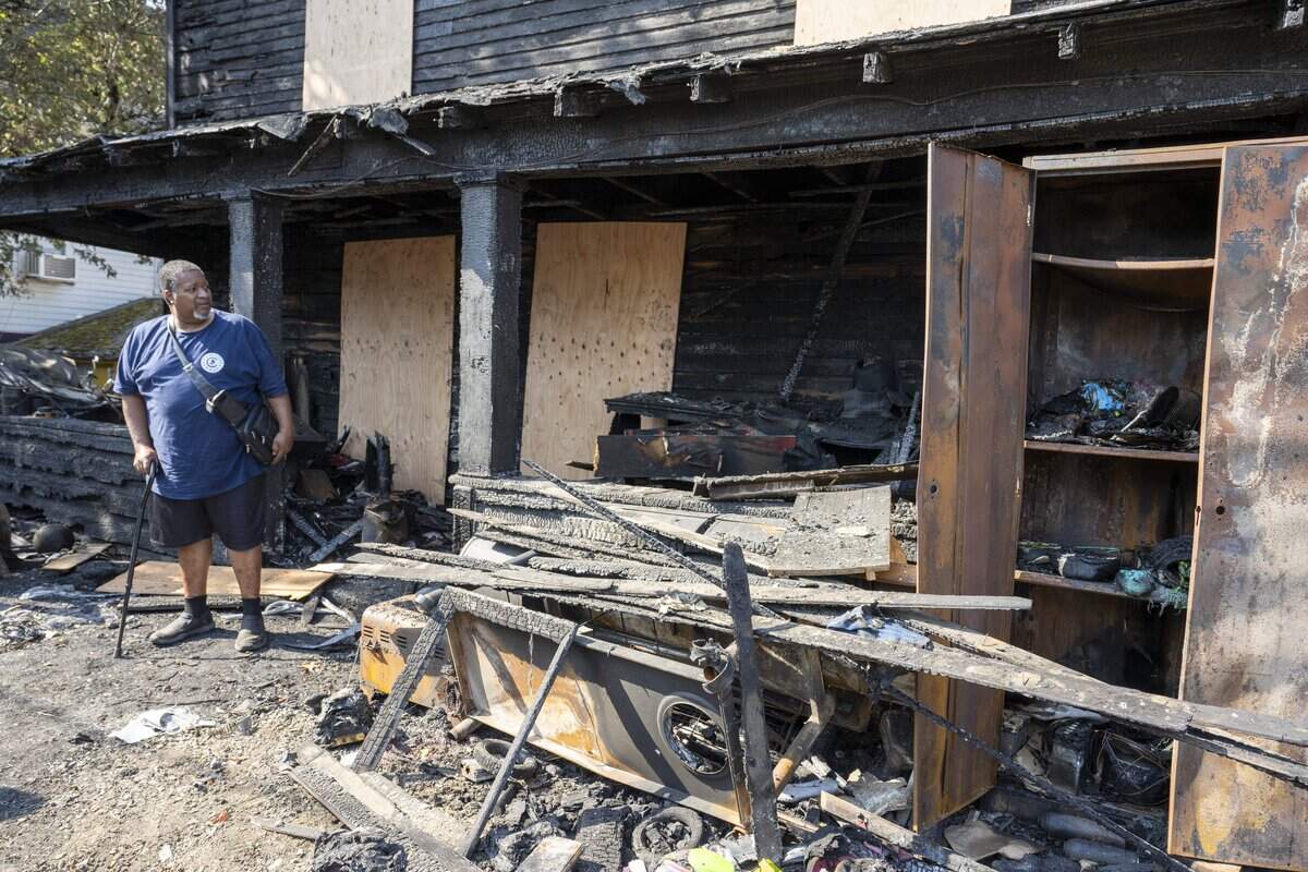 Bishop Enoch Brooks stands among debris outside of his house on Thursday, Sept. 18, 2025, which was lost to a fire the weekend before along with Brooks' motorhome and two family cars, in Tacoma.