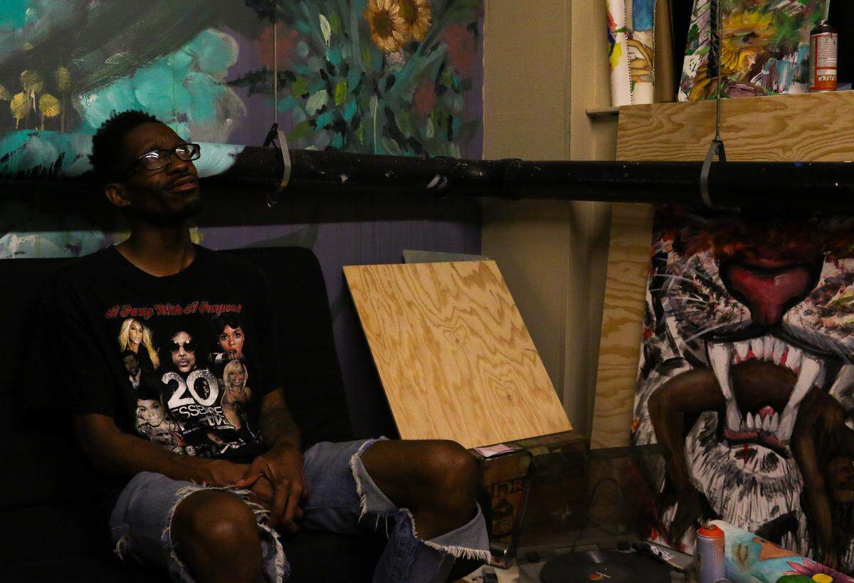 Artist Perry Porter, who grew up in Spanaway, looks around his art studio in Seattle on July 22, 2019. Porter became a full-time artist about three years ago and has sold paintings to former Seattle Seahawk Marshawn Lynch, among others.