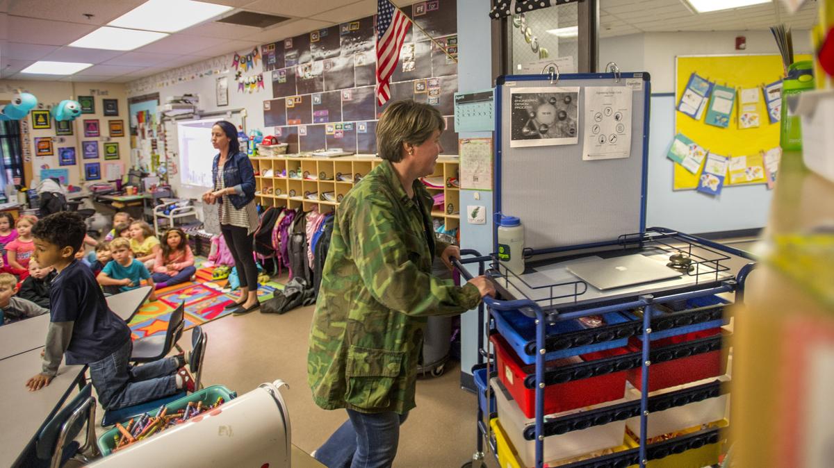 Camille Schuette takes her “science a la cart” lesson to her next classroom at Minter Creek Elementary School on April 12, 2018.  Lack of space at the school forces her to work from a cart instead of a classroom. A $220 million bond measure that would have helped Minter with upgrades failed in April.