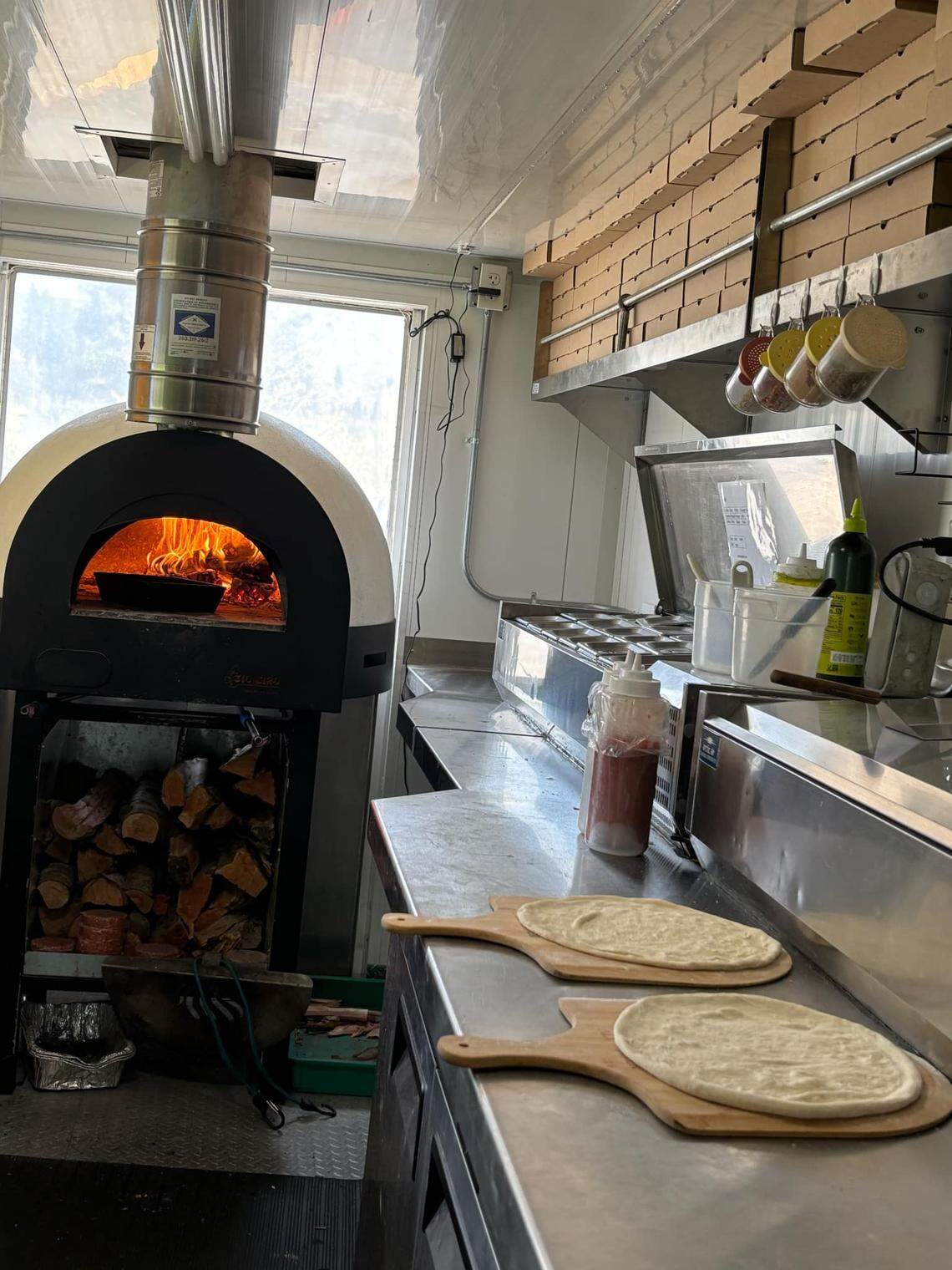 Samuel Ranz makes pizzas inside one of the couple’s two food trucks outside the Gordon Family YMCA on April 9.