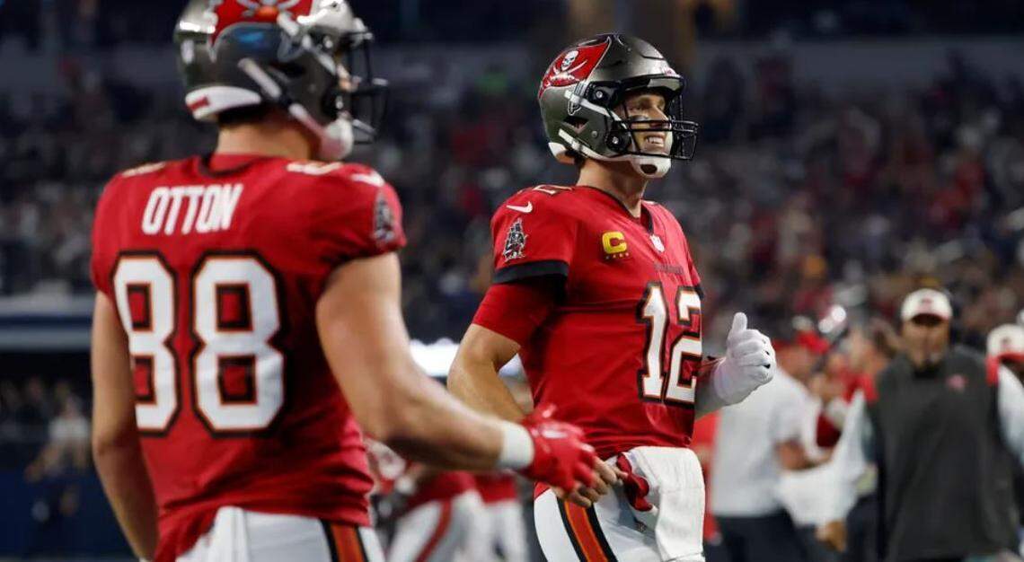 Tampa Bay Buccaneers tight end Cade Otton (88) and quarterback Tom Brady (12) celebrate after Mike Evans caught a touchdown pass in the second half of a NFL football game against the Dallas Cowboys in Arlington, Texas, Sunday, Sept. 11, 2022.