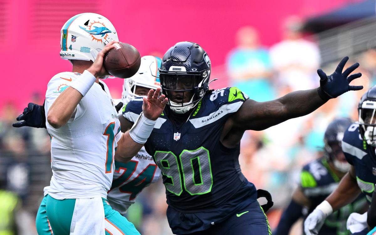 Seattle Seahawks defensive tackle Jarran Reed (90) pressures Miami Dolphins quarterback Tim Boyle (14) during the fourth quarter of the game at Lumen Field, on Sunday, Sept. 22, 2024, in Seattle, Wash.