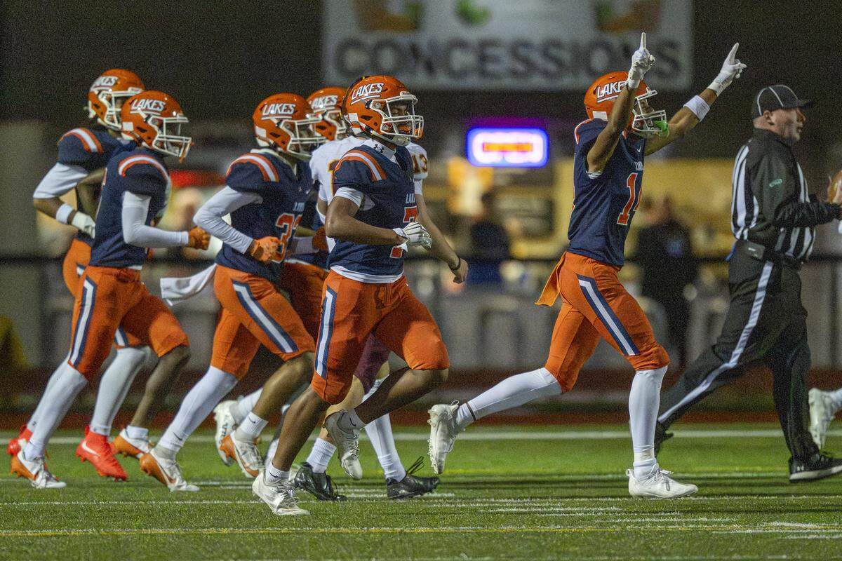 Lakes players celebrate their first touchdown against Capital on Friday, Oct. 24, 2025, in Lakewood, Wash.