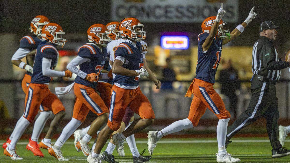 Lakes players celebrate their first touchdown against Capital on Friday, Oct. 24, 2025, in Lakewood, Wash.