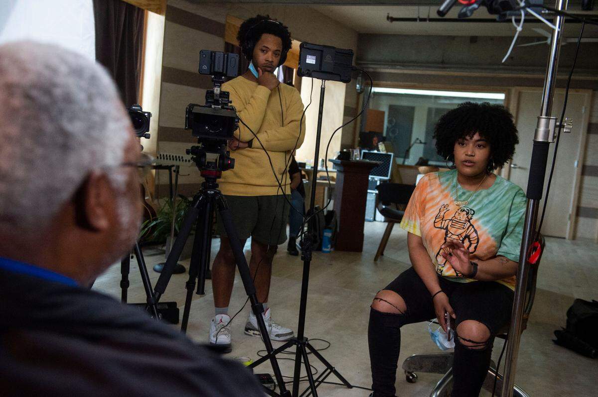 Tacoma students Jazmyn Pratt, right, and her brother Aaron interview Metro Parks Board Commissioner Aaron Pointer at ALMA’s recording studio on Sunday, June 13, 2021. Providing such a space for youth development was central to the organization’s mission.