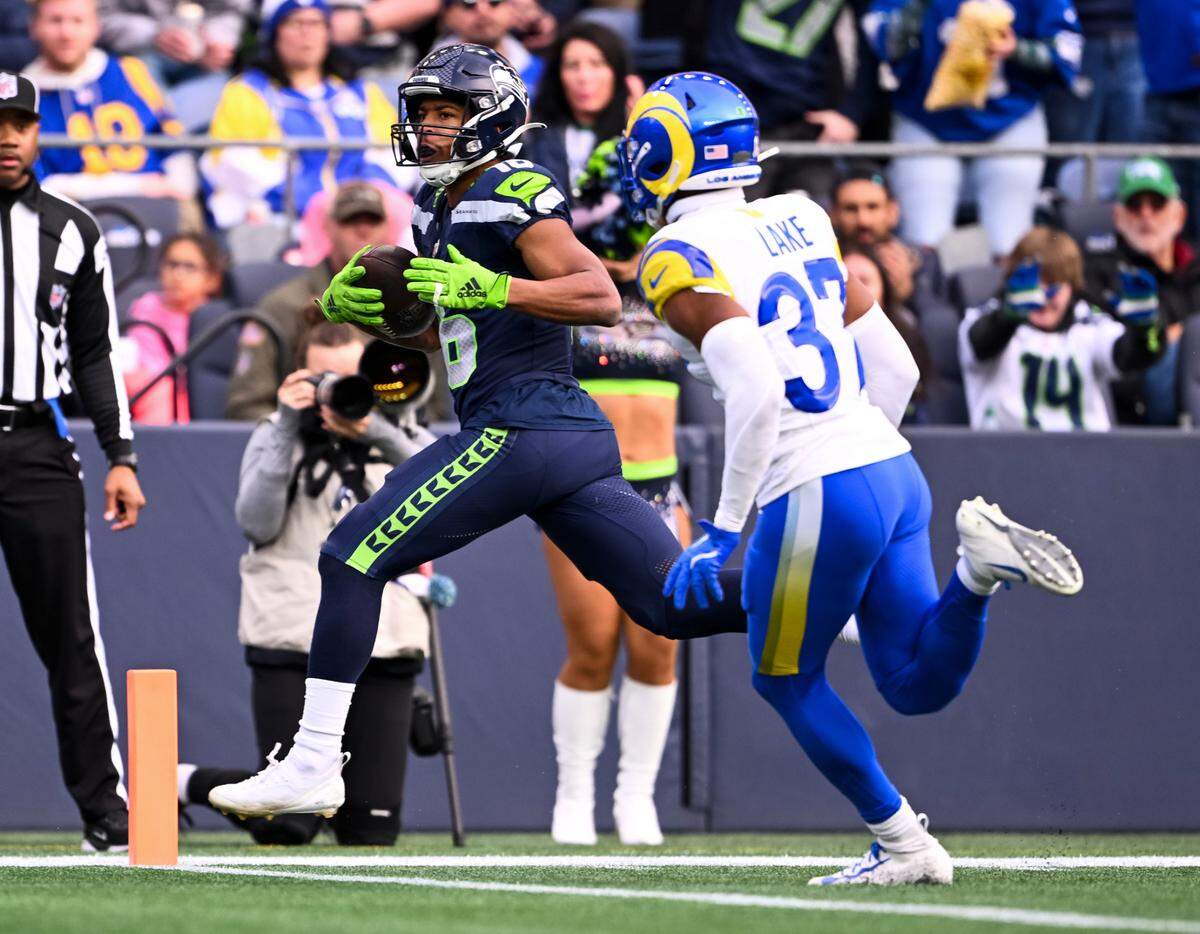 Seattle Seahawks wide receiver Tyler Lockett (16) runs in a touchdown against Los Angeles Rams safety Quentin Lake (37) during the second quarter of the game at Lumen Field, on Sunday, Nov. 3, 2024 in Seattle, Wash.