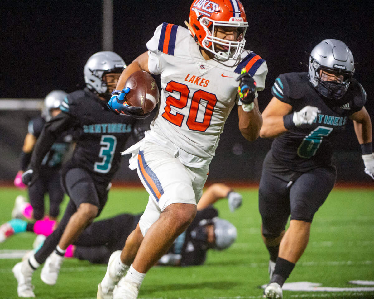 Lakes running back Leo Pulalasi breaks through the Spanaway Lake defense as he rushes for a touchdown in the third quarter of a 3A Pierce County League game on Friday at Art Crate Field in Spanaway.