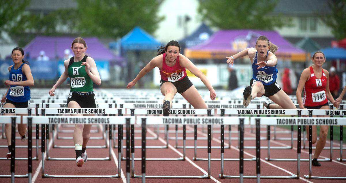 Enumclaw’s Ellie DeGroot (center) runs to a state championship in the 2A girls 100-meter hurdles during the second day of the WIAA State Track and Field Championships at Mount Tahoma High School in Tacoma, Washington on Friday, May 27, 2022.