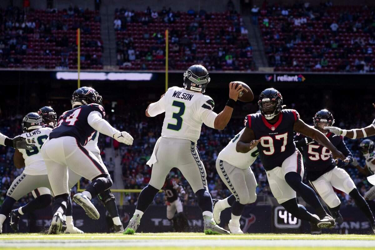 Quarterback (3) Russell Wilson of the Seattle Seahawks passes the ball against the Houston texans in an NFL football game, Sunday, Dec. 12, 2021, in Houston, TX. (AP Photo/Jeff Lewis)