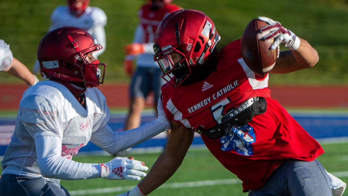 Kennedy Catholic receiver Junior Alexander looks for extra yardage after catching a Sam Huard pass at practice in Burien on Monday, March 9, 2021.