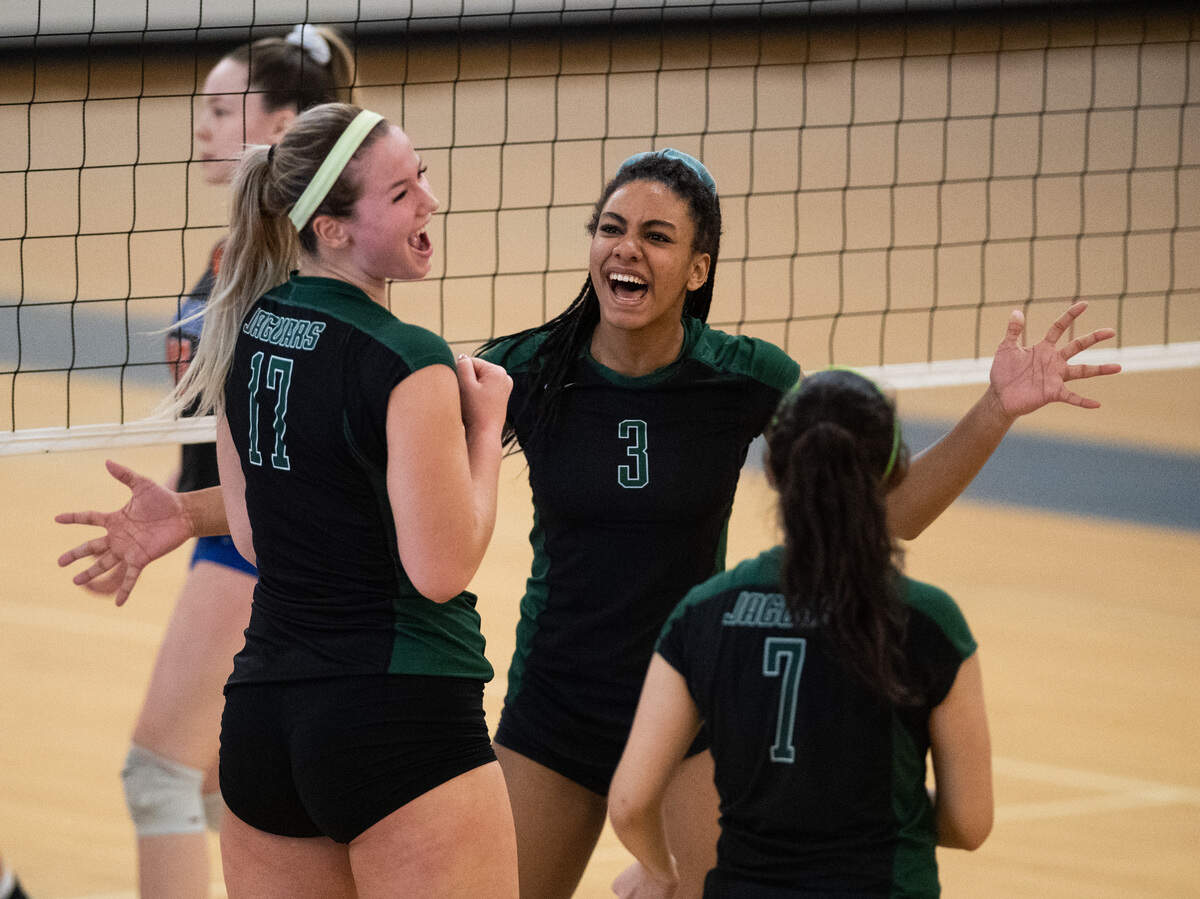 Emerald Ridge’s Ella Litterell, Alivia Kinsman, and Sandra Torres, celebrate a point during the first set. Graham-Kapowsin played Emerald Ridge in the 4A West Central District Final at Curtis High School in Tacoma, Wash., on Saturday, Nov. 16, 2019.