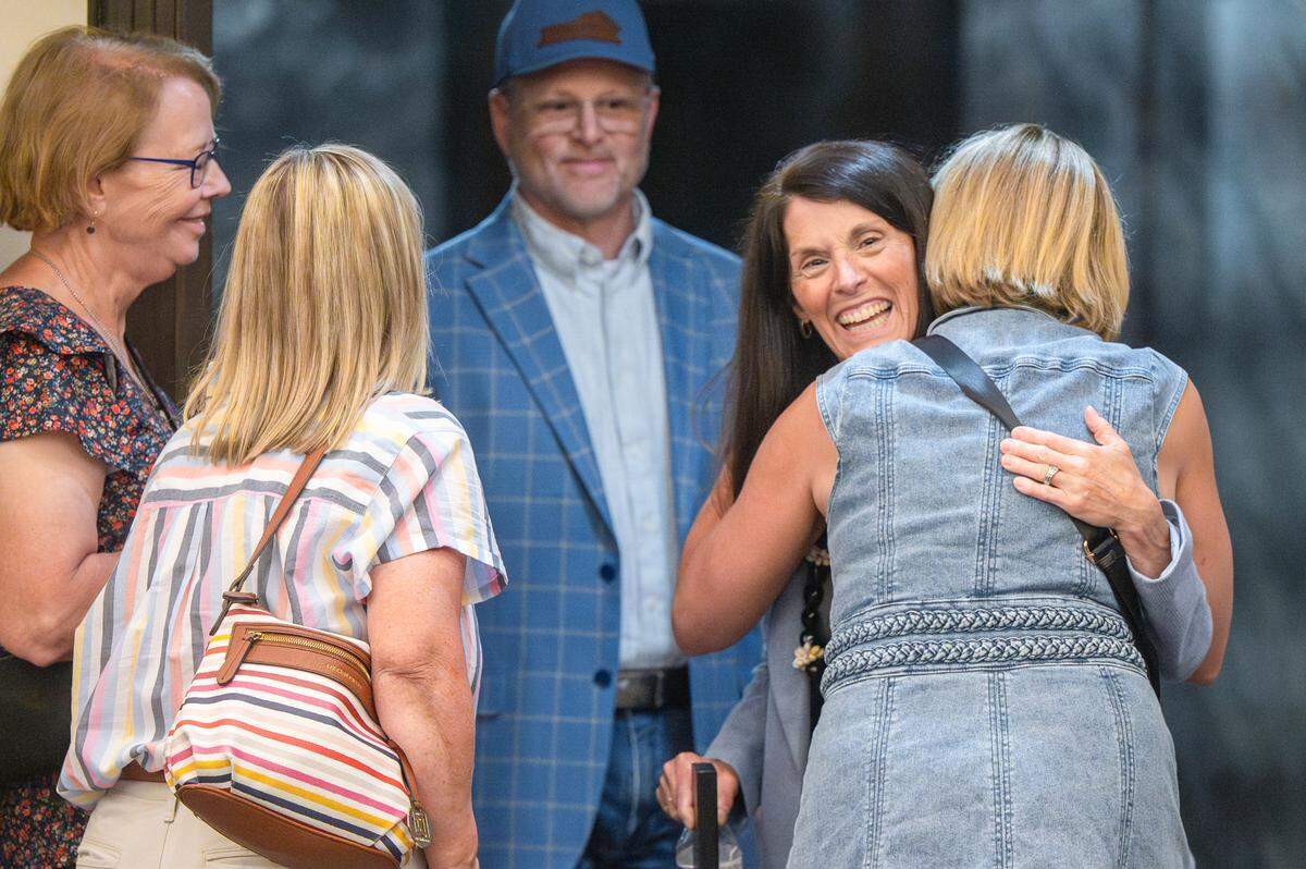 Retiring Tacoma City Manager Elizabeth Pauli, center, is hugged before a City Council meeting on Tuesday, July 1, 2025, in Tacoma.