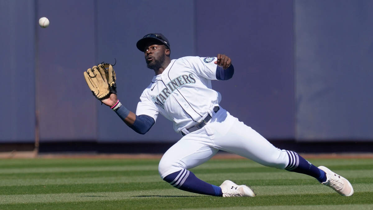 Seattle Mariners center fielder Taylor Trammell catches a fly ball hit by Oakland Athletics’ Greg Deichmann during the second inning of a spring training baseball game Saturday, March 6, 2021, in Peoria, Ariz. (AP Photo/Sue Ogrocki)