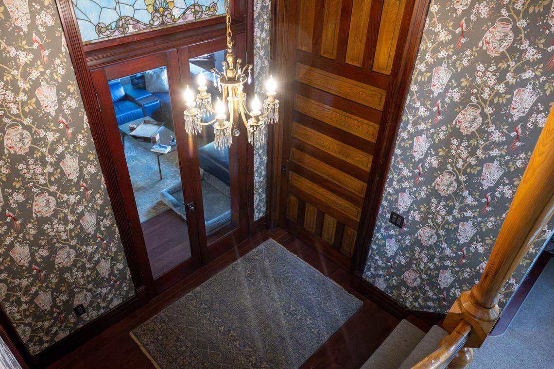 The foyer of the Hoska House includes original woodwork on the stairs leading to the second floor and wallpaper intended to match what would likely be the home’s original style on Wednesday, April 30, 2025, along North D Street in Tacoma, Wash.