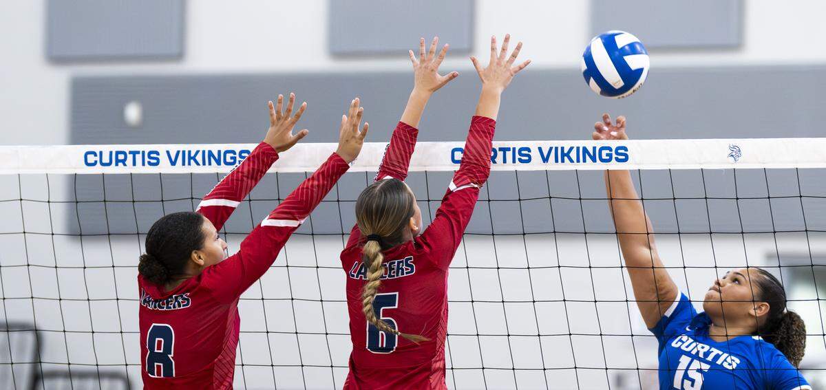 Curtis right side/middle blocker Kayla Baker (15) hits the ball against Kennedy Catholic outside hitter Acacia Lloyd-Aguiar (8) andmiddle blocker Pela Ivey (6) during the volleyball match at Curtis Senior High School, on Thursday, Sept. 18, 2025, in University Place.