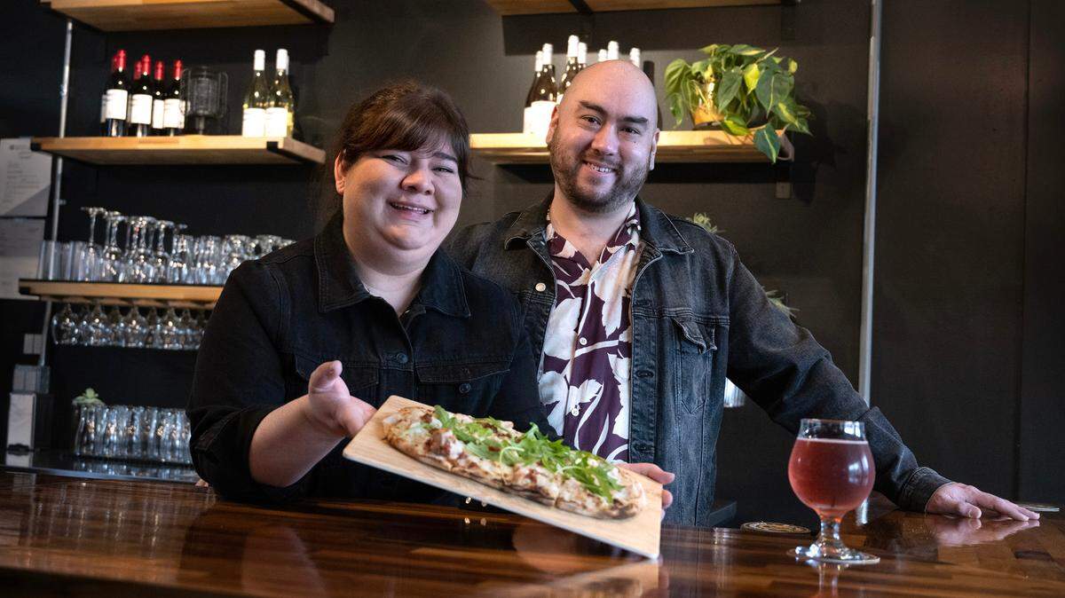 Christina Sanchez and partner Jeremy McDonald have opened The Crafty Beaver, a beer and wine lounge in downtown Tacoma. They are shown here with the Chicken Bacon Caesar pizza and rosé cider on Thursday, Jan. 25.