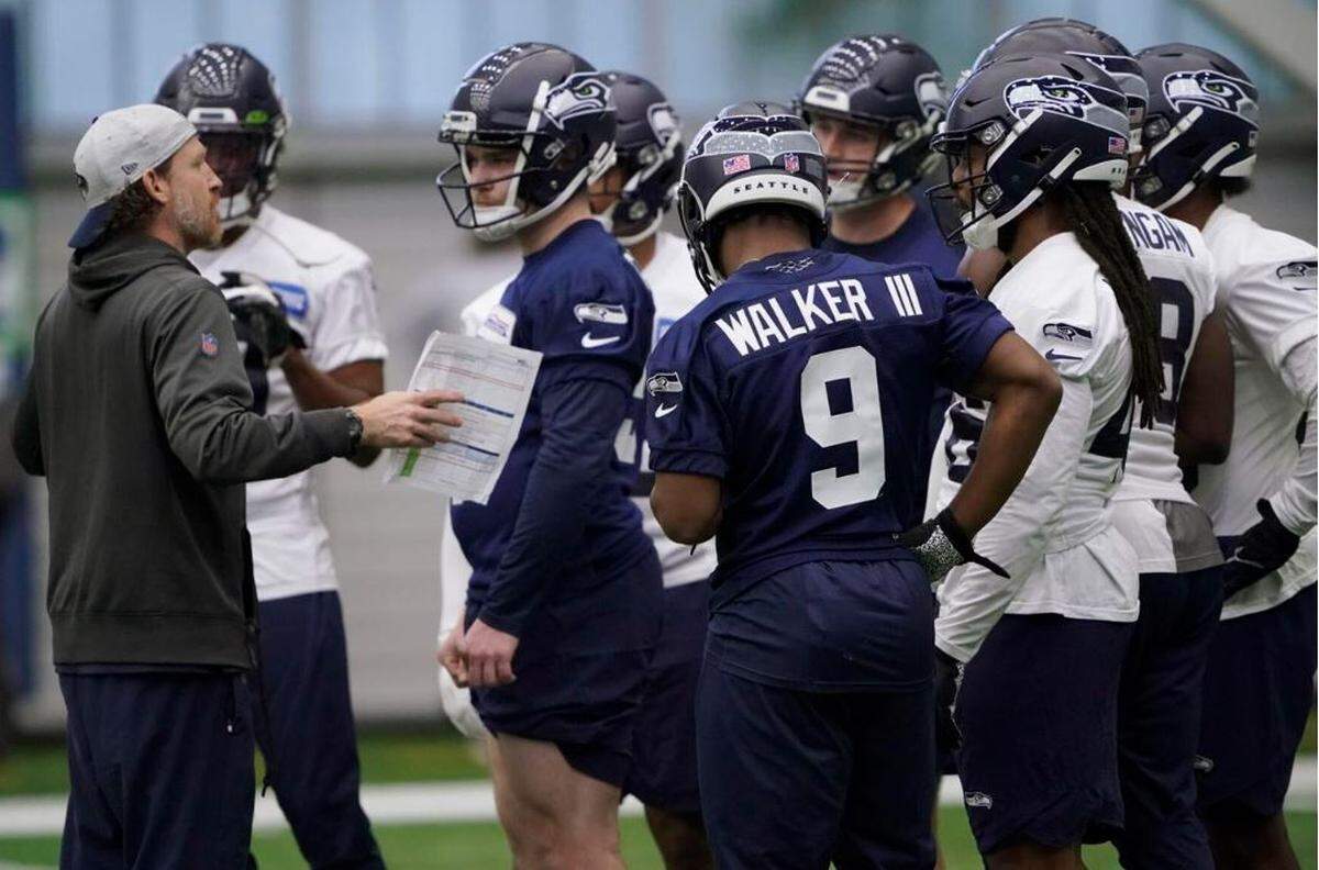 Special-teams coach Larry Izzo, left, talks to Ken Walker III (9) and fellow participants in the Seahawks’ rookie minicamp on Friday at the Virginia Mason Athletic Center in Renton.