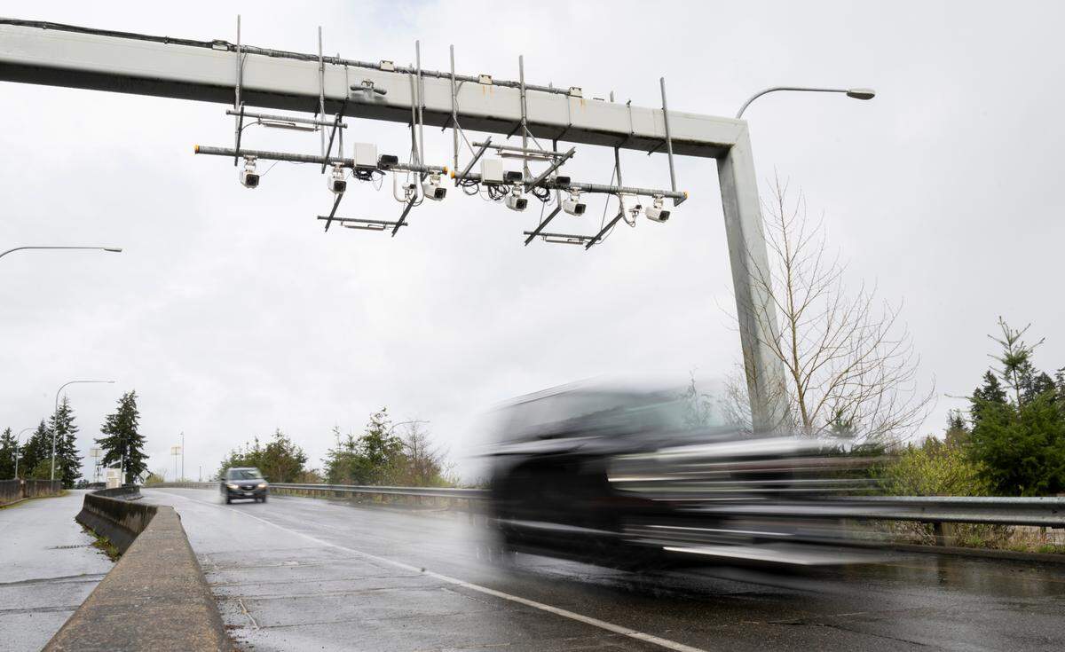 Cars pass under the automated license plate cameras and pass readers on an onramp on WA-16, on Thursday, March 13, 2025, in Gig Harbor, Wash.