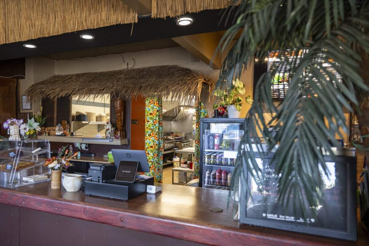 Da Tiki Hut's entrance features a counter for to-go orders and a view into the kitchen on Thursday, July 9, 2026, in Tacoma, Wash. A tropical themed dining room is hidden behind a door to the left of the counter.