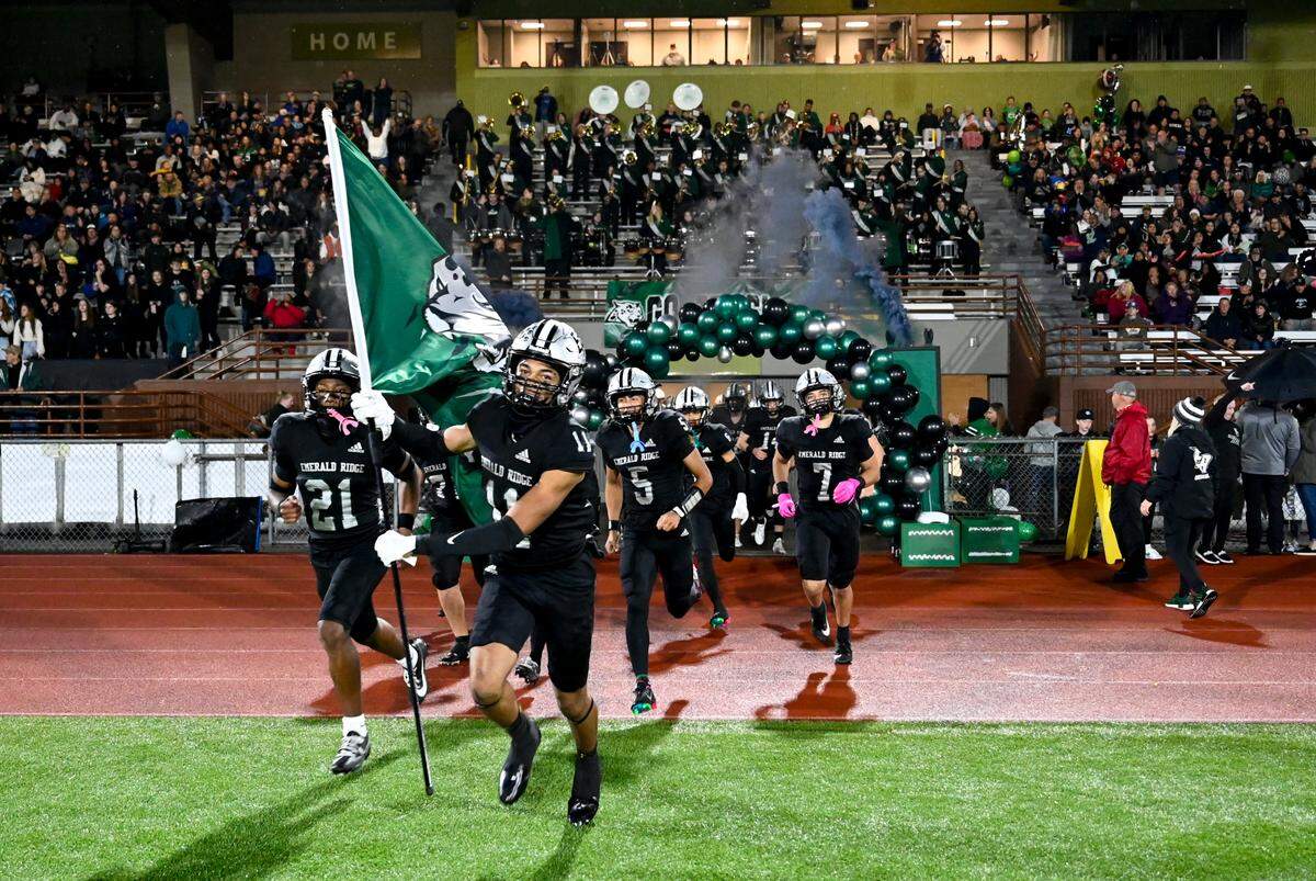 Emerald Ridge runs out on to the field before the first half of the game between Graham-Kapowsin and Emerald Ridge at Sparks Stadium, Saturday, Oct. 21, 2023, in Puyallup, Wash.