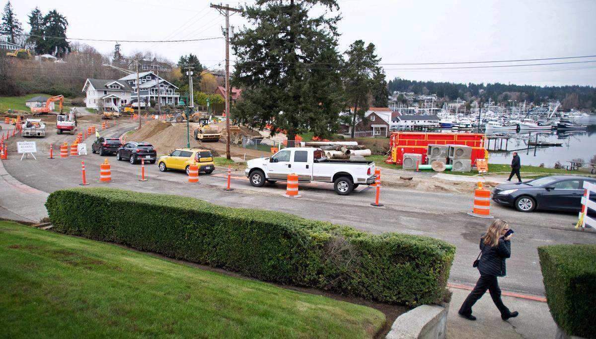 One-way traffic flows northbound through the roundabout construction project at Harborview Drive and Stinson Avenue along the downtown waterfront in Gig Harbor, Washington, on Friday, March 11, 2022. Southbound traffic faces a seven-mile detour route around the site.