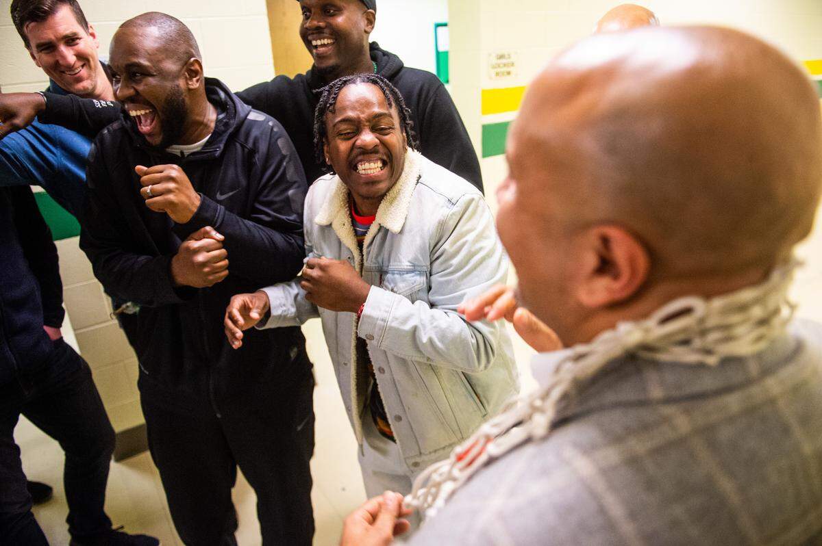 Members of Foss’ 2000 state title team joke in the tunnel before they are announced during a halftime ceremony. Foss played White River in a basketball game at Foss High School in Tacoma, Wash., on Friday, Jan. 31, 2020.
