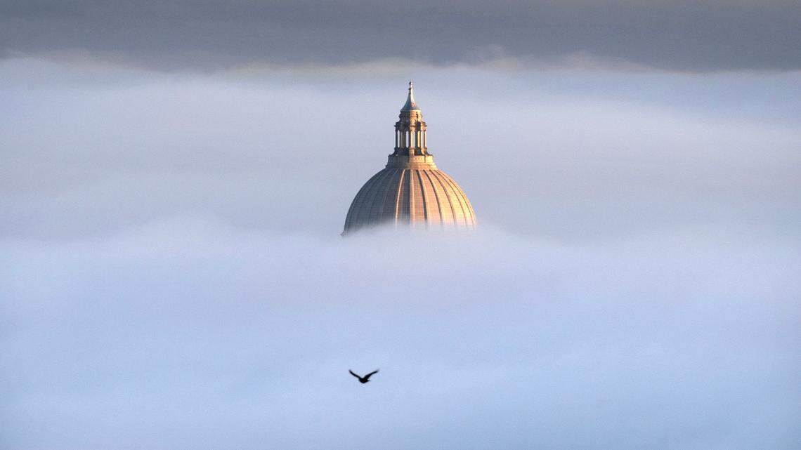 The Washington State Capitol pops out of the fog on a freezing morning as seen from Overlook Point Park in Tumwater, Washington, on Friday, Nov. 24, 2023.