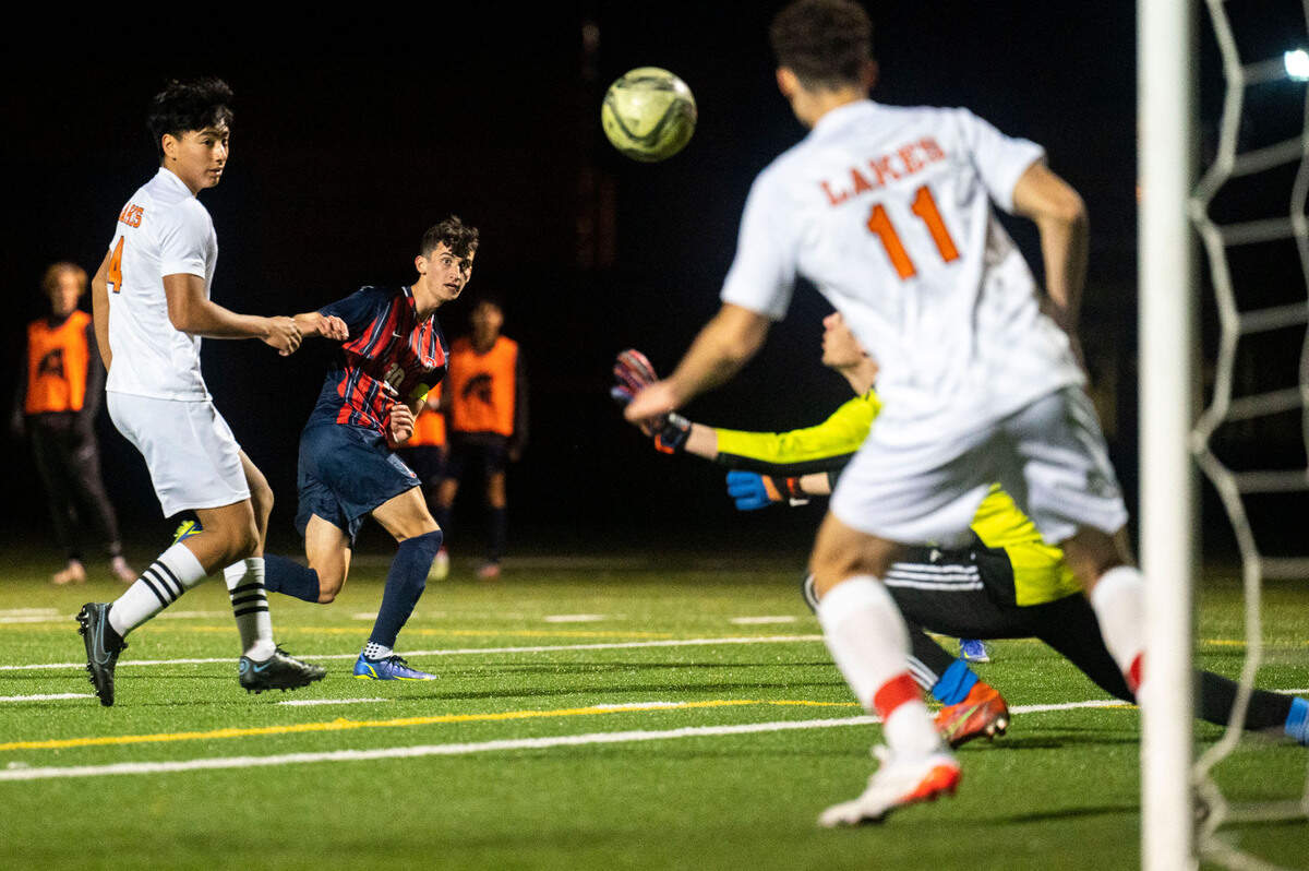 Silas midfielder Connor Tollan watches as his shot on goal is saved by Lakes goalkeeper Jonathan Bieber during the second half of a Pierce County League game on Thursday, March 31, 2022, at Silas High School in Tacoma, Wash.