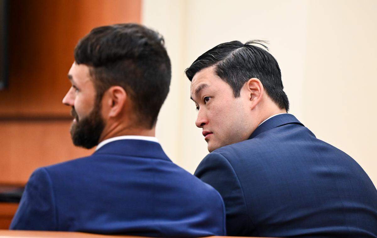 Tacoma police officers Christopher “Shane” Burbank and Timothy Rankine sit in the gallery during pre-trial motions last month.