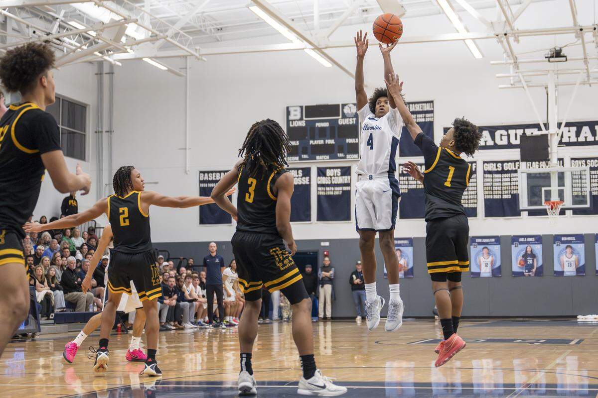 Bellarmine Lions freshman Donovyn Frazier (4) attempts a three-point shot with pressure from Lincoln Abes junior Oshea Lamar (1) on Wednesday, Jan. 28, 2026, in Tacoma, Wash.