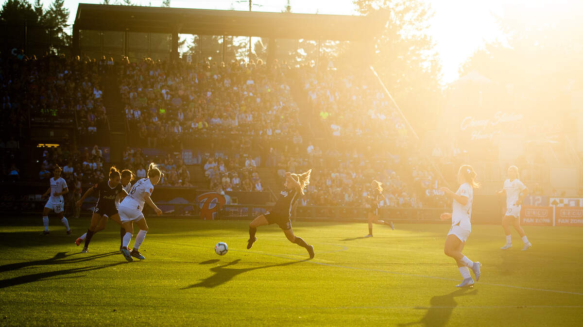 Reign FC’s Rosie White passes the ball while on an attacking run in the first half. Reign FC played the Portland Thorns in a National Women’s Soccer League match at Cheney Stadium in Tacoma, Wash., on Wednesday, Aug. 7, 2019.